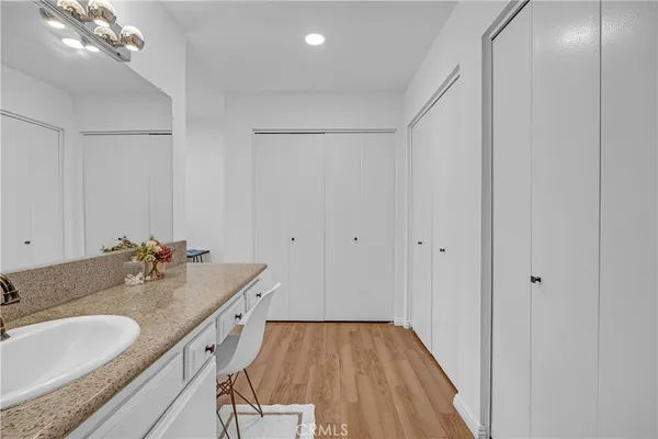 a bathroom with a granite countertop sink a toilet and a mirror