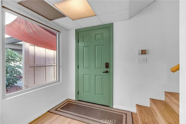 a view of entryway and hall with wooden floor