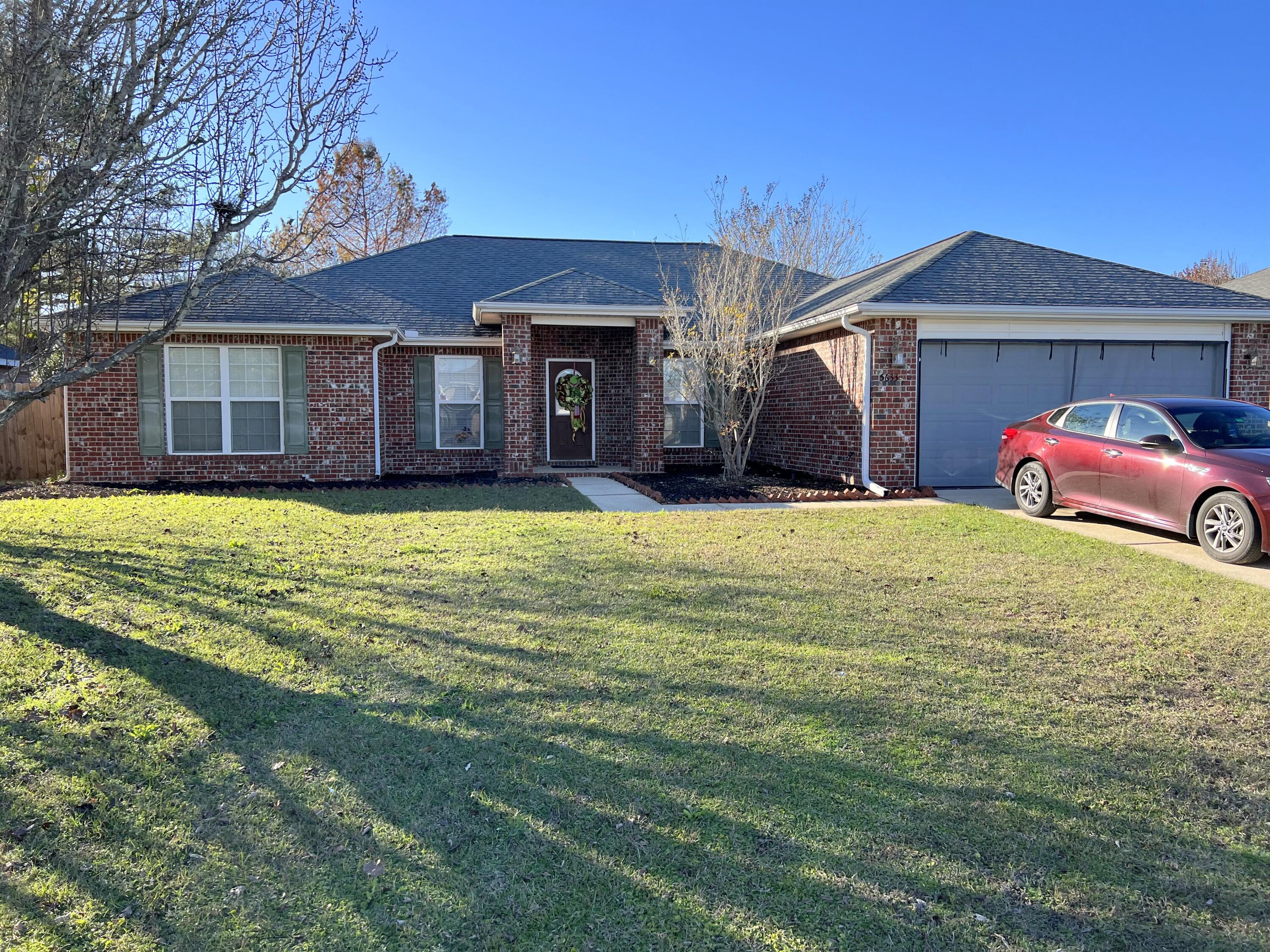 5633 North Brook Drive Crestview, FL 32539 - Photo 1 of 28 a view of a house with a big yard and large trees