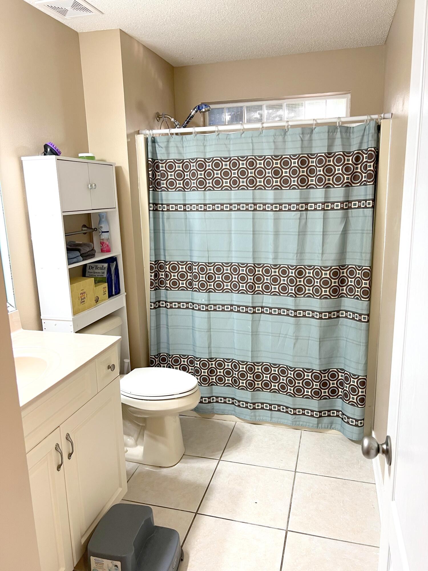 5633 North Brook Drive Crestview, FL 32539 - Photo 11 of 28 a bathroom with a toilet a sink and shower