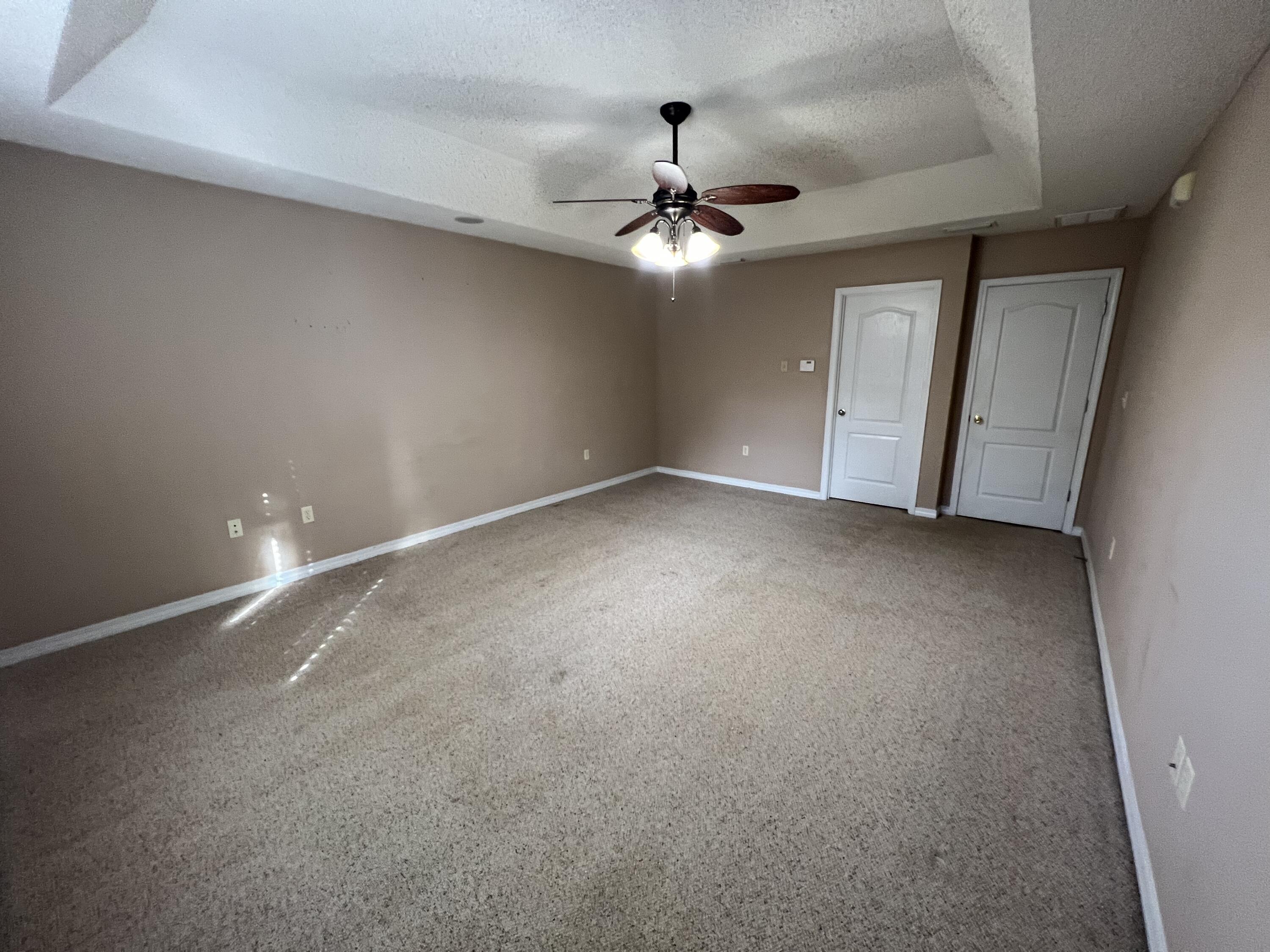 5633 North Brook Drive Crestview, FL 32539 - Photo 12 of 28 en empty room with windows and ceiling fan