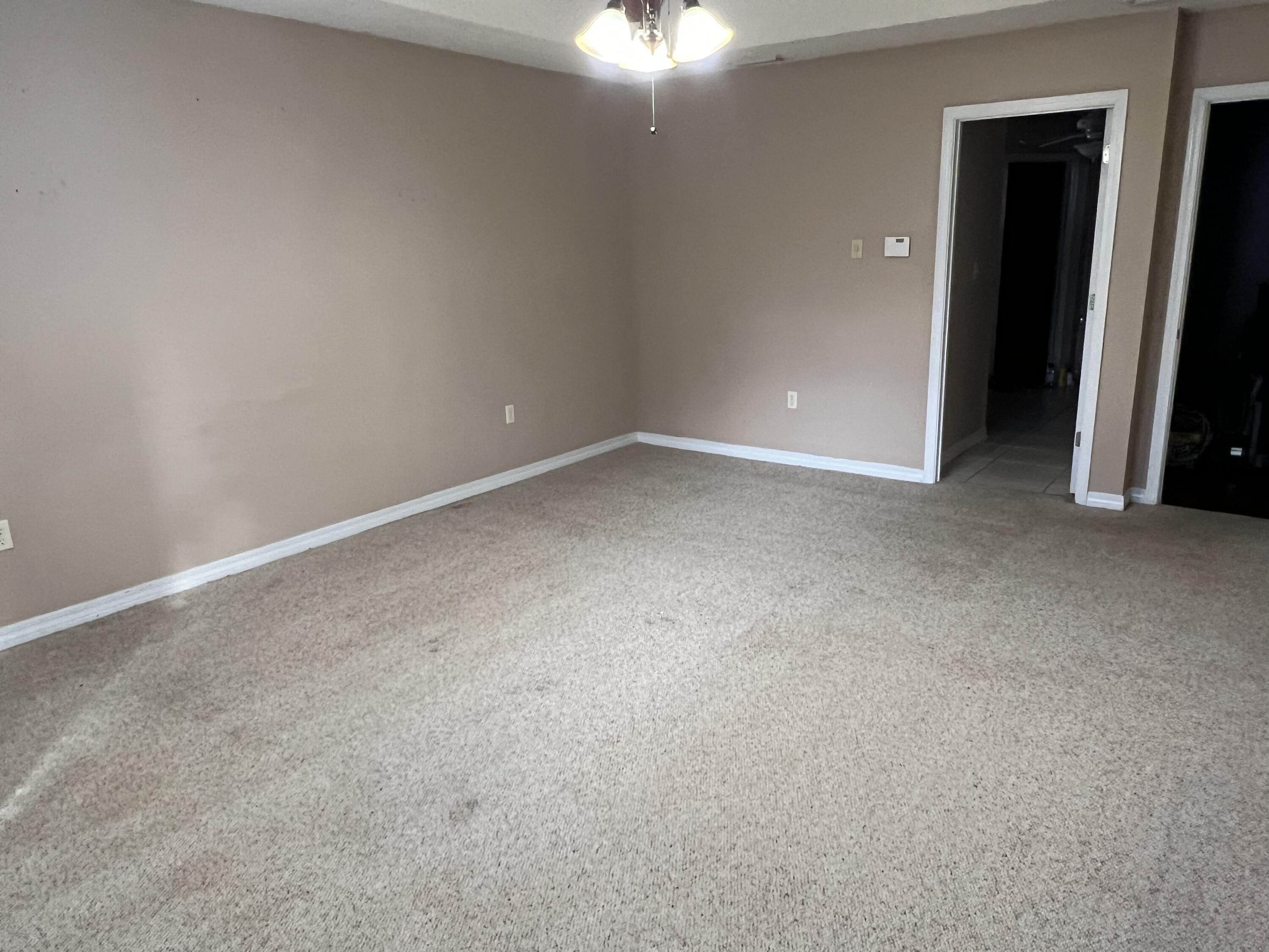 5633 North Brook Drive Crestview, FL 32539 - Photo 14 of 28 an empty room with closet and a chandelier fan