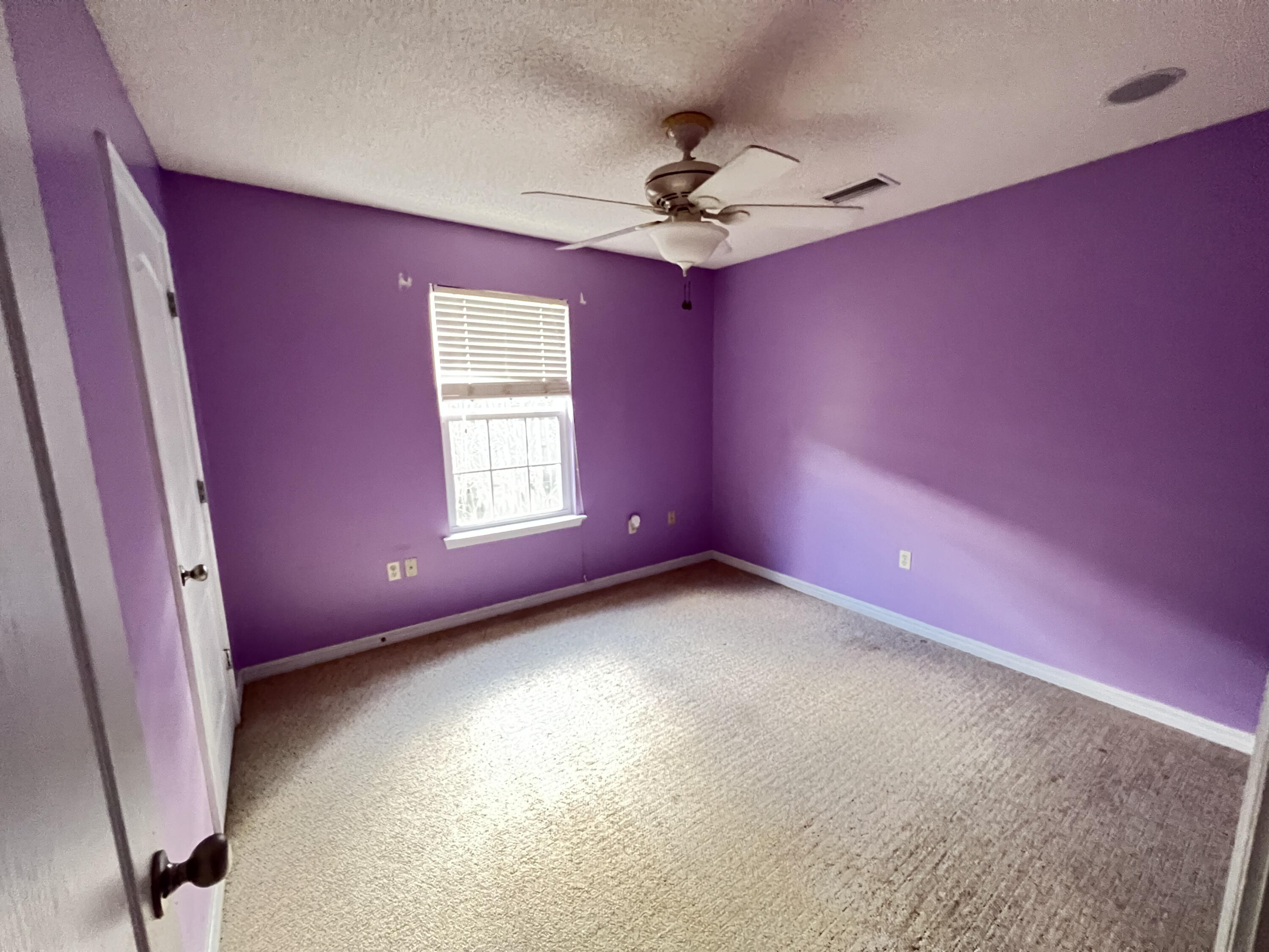 5633 North Brook Drive Crestview, FL 32539 - Photo 16 of 28 a view of a livingroom with a fan a ceiling fan and window