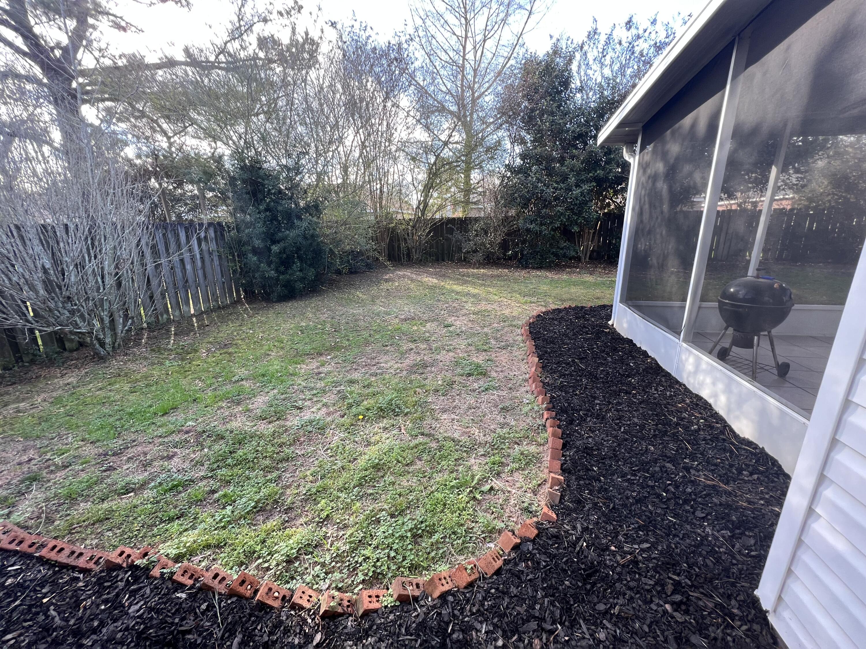 5633 North Brook Drive Crestview, FL 32539 - Photo 17 of 28 a backyard of a house with lots of green space