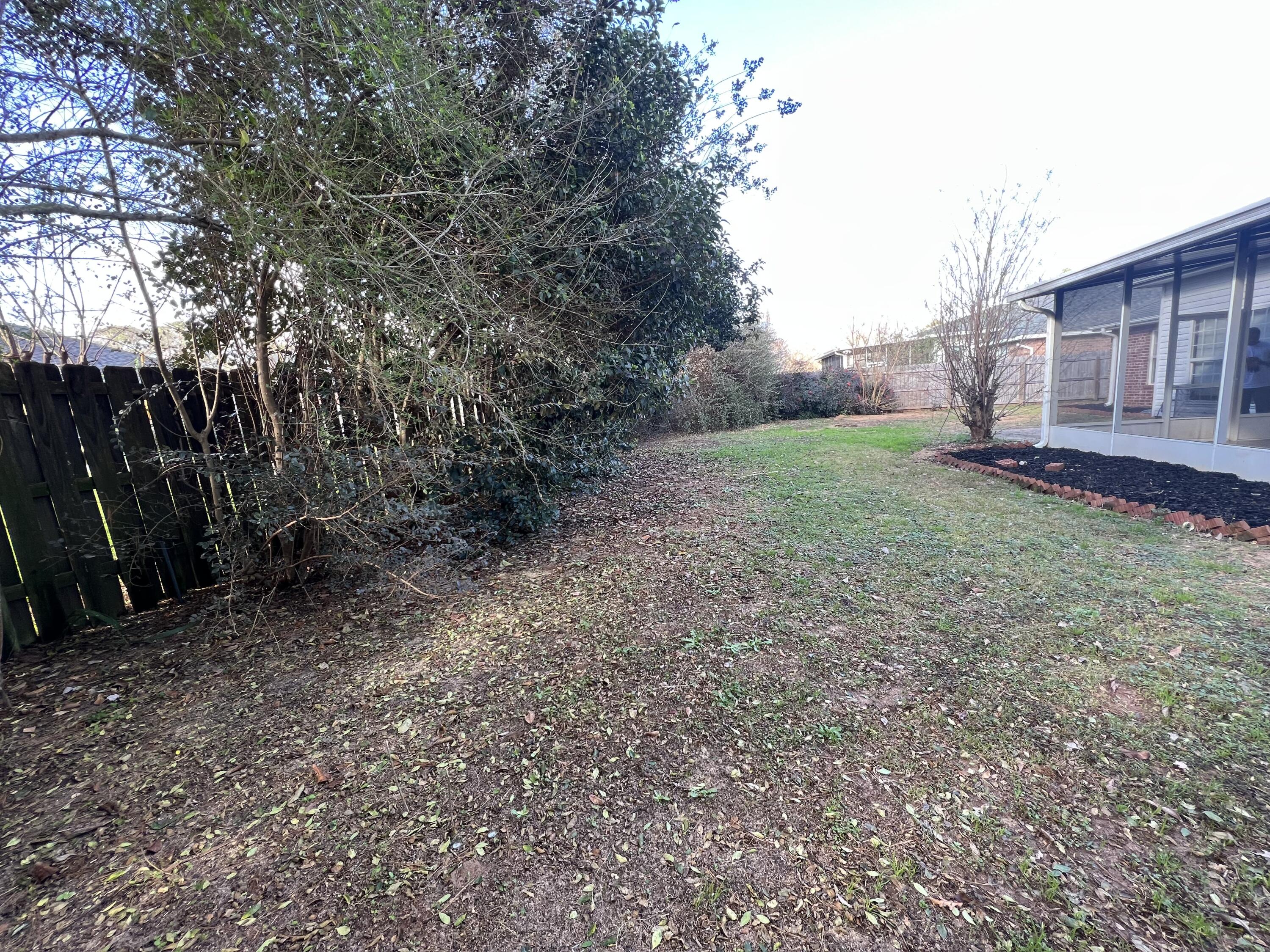 5633 North Brook Drive Crestview, FL 32539 - Photo 18 of 28 a view of a backyard with large trees