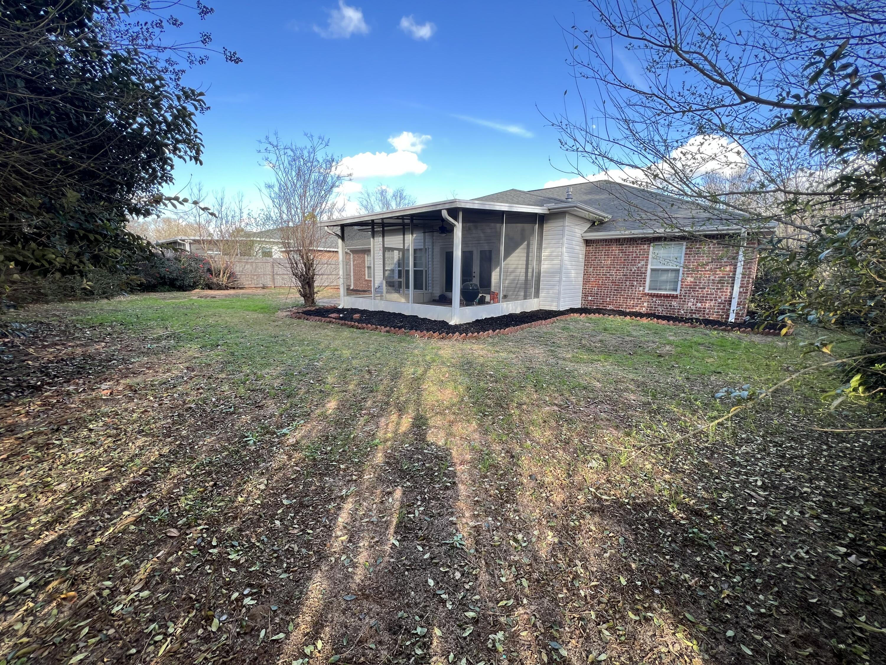 5633 North Brook Drive Crestview, FL 32539 - Photo 19 of 28 a view of a house with backyard and garden