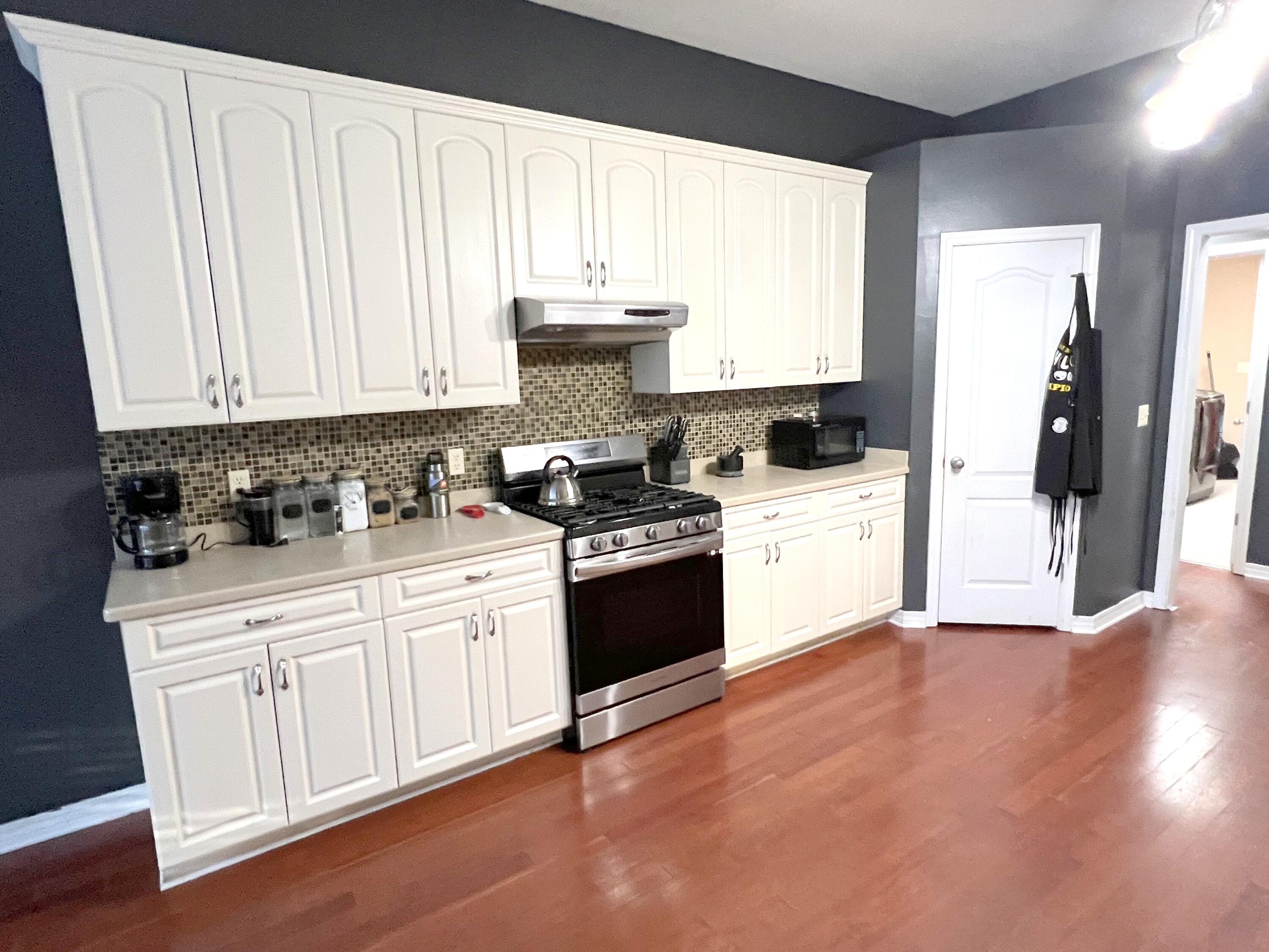 5633 North Brook Drive Crestview, FL 32539 - Photo 2 of 28 a kitchen with granite countertop white cabinets and white appliances