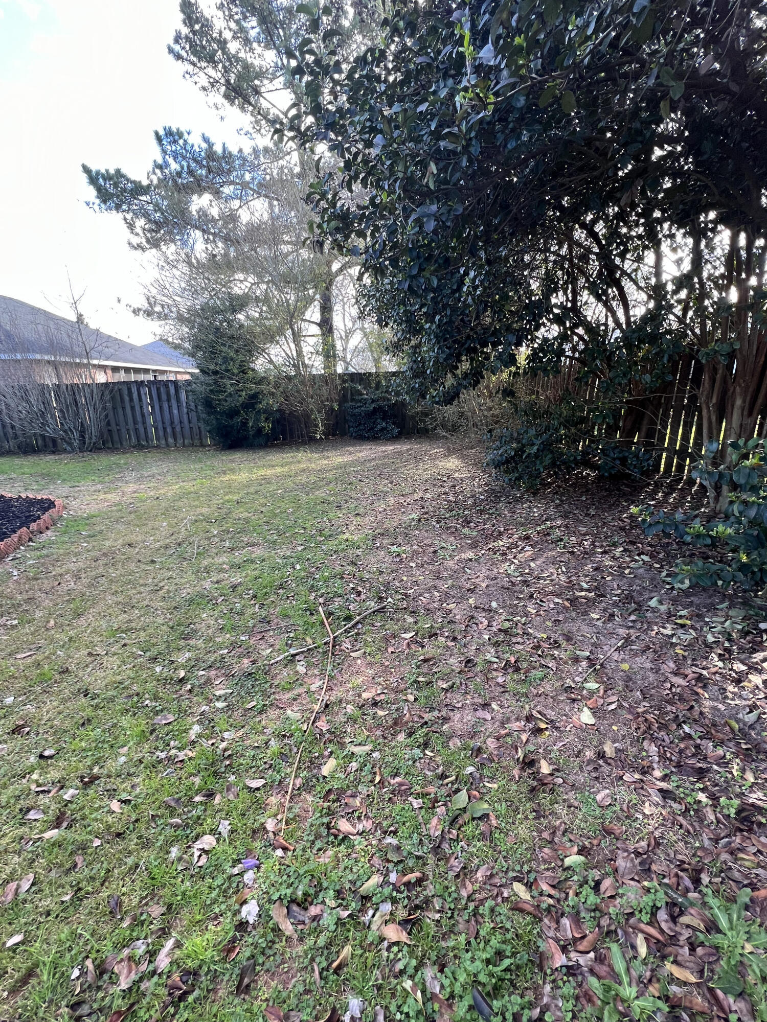 5633 North Brook Drive Crestview, FL 32539 - Photo 25 of 28 a backyard of a house with lots of green space