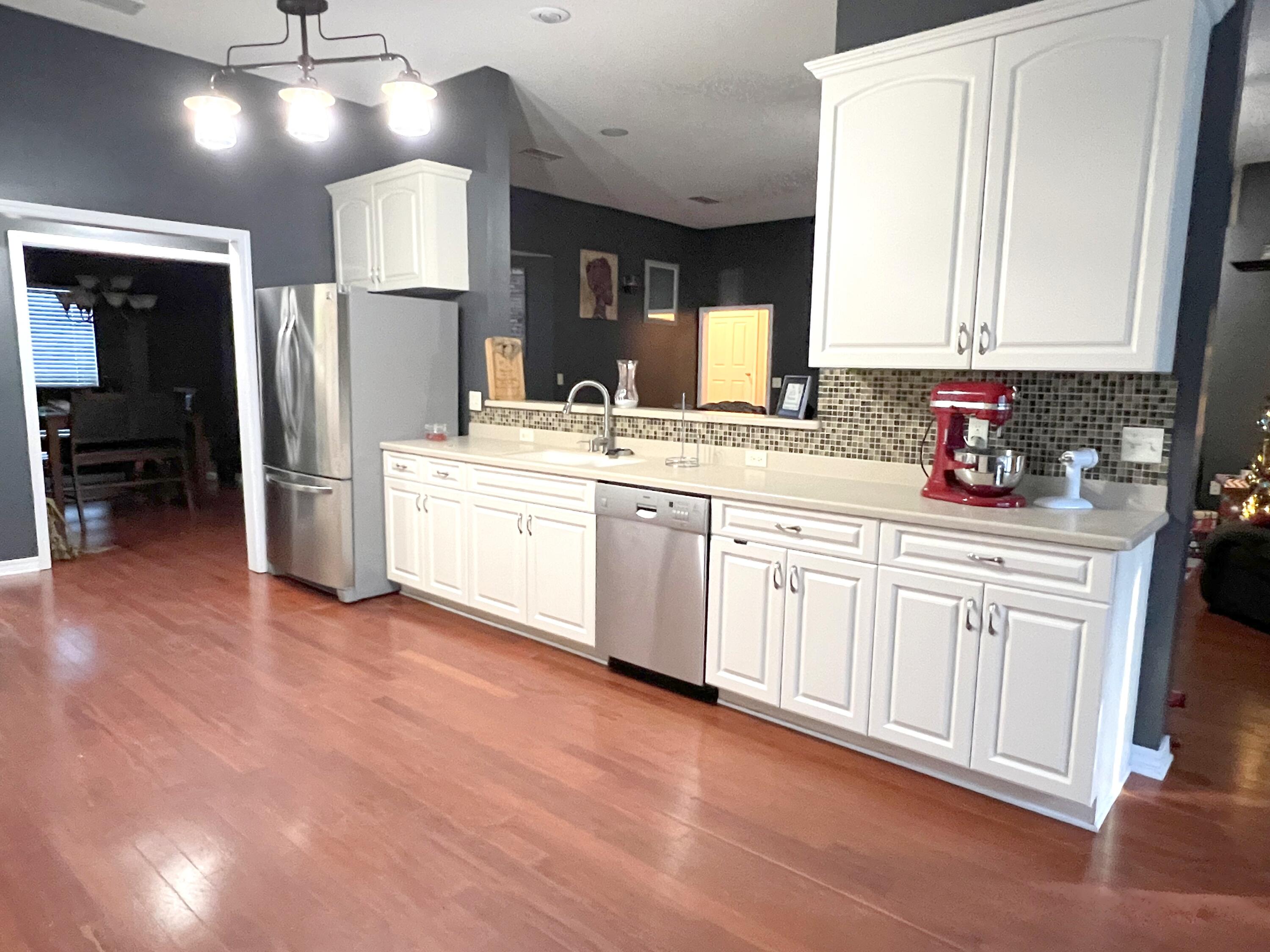 5633 North Brook Drive Crestview, FL 32539 - Photo 3 of 28 a kitchen with stainless steel appliances a sink stove and refrigerator