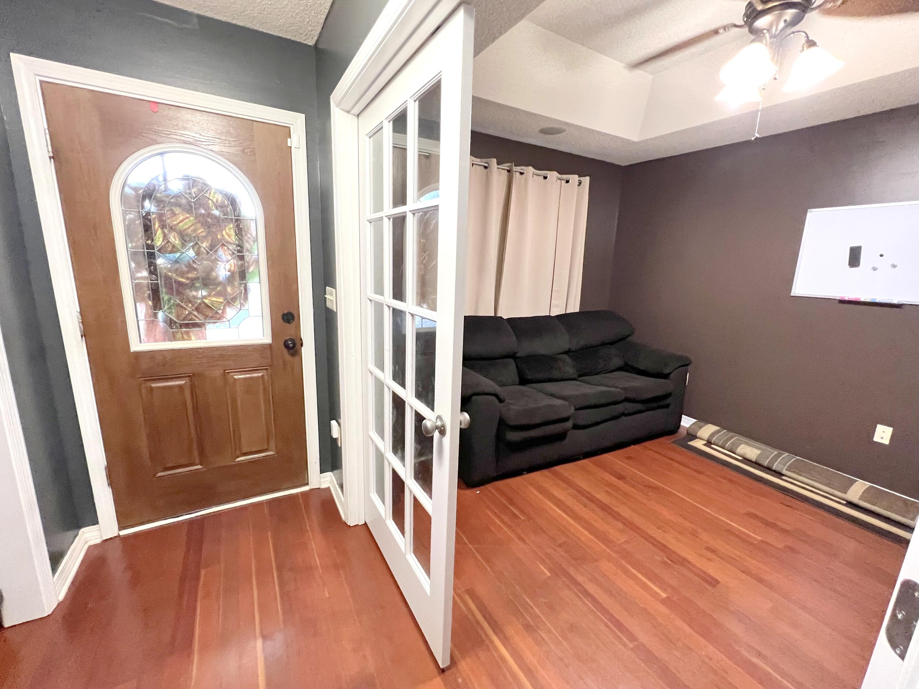 5633 North Brook Drive Crestview, FL 32539 - Photo 4 of 28 a view of an empty room with wooden floor and a window