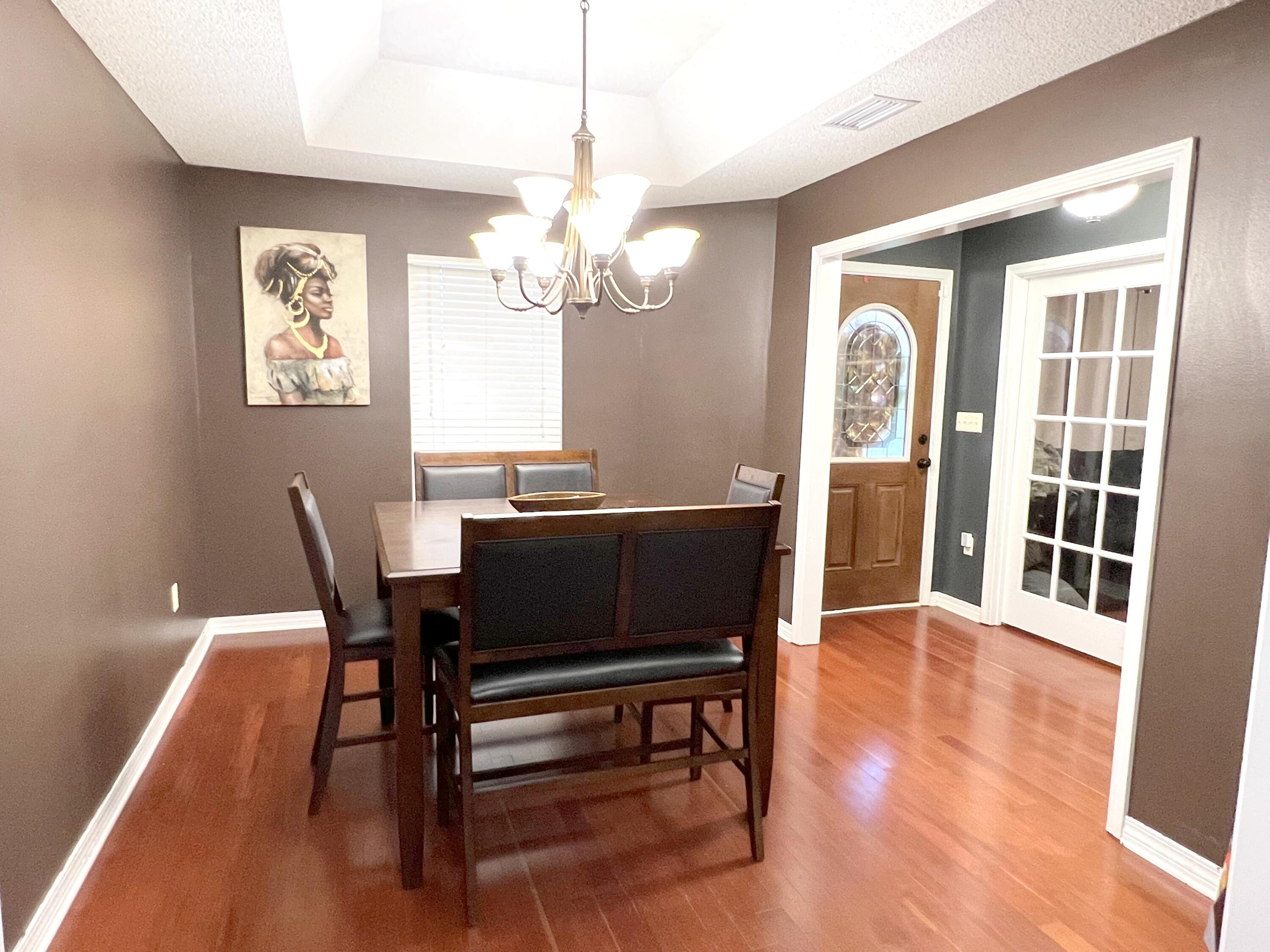 5633 North Brook Drive Crestview, FL 32539 - Photo 5 of 28 a view of a dining room with furniture window and wooden floor