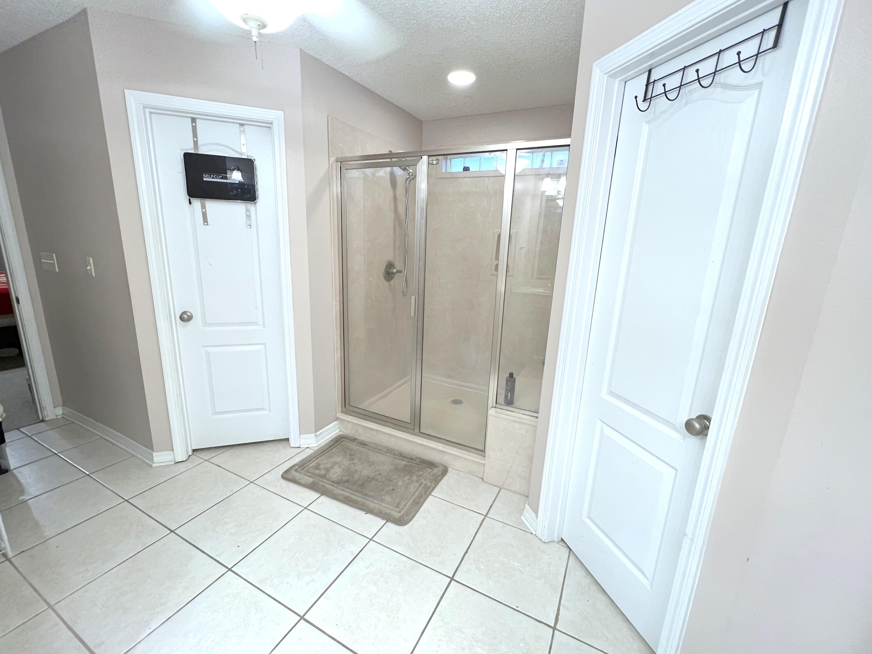 5633 North Brook Drive Crestview, FL 32539 - Photo 6 of 28 a bathroom with a shower and a mirror