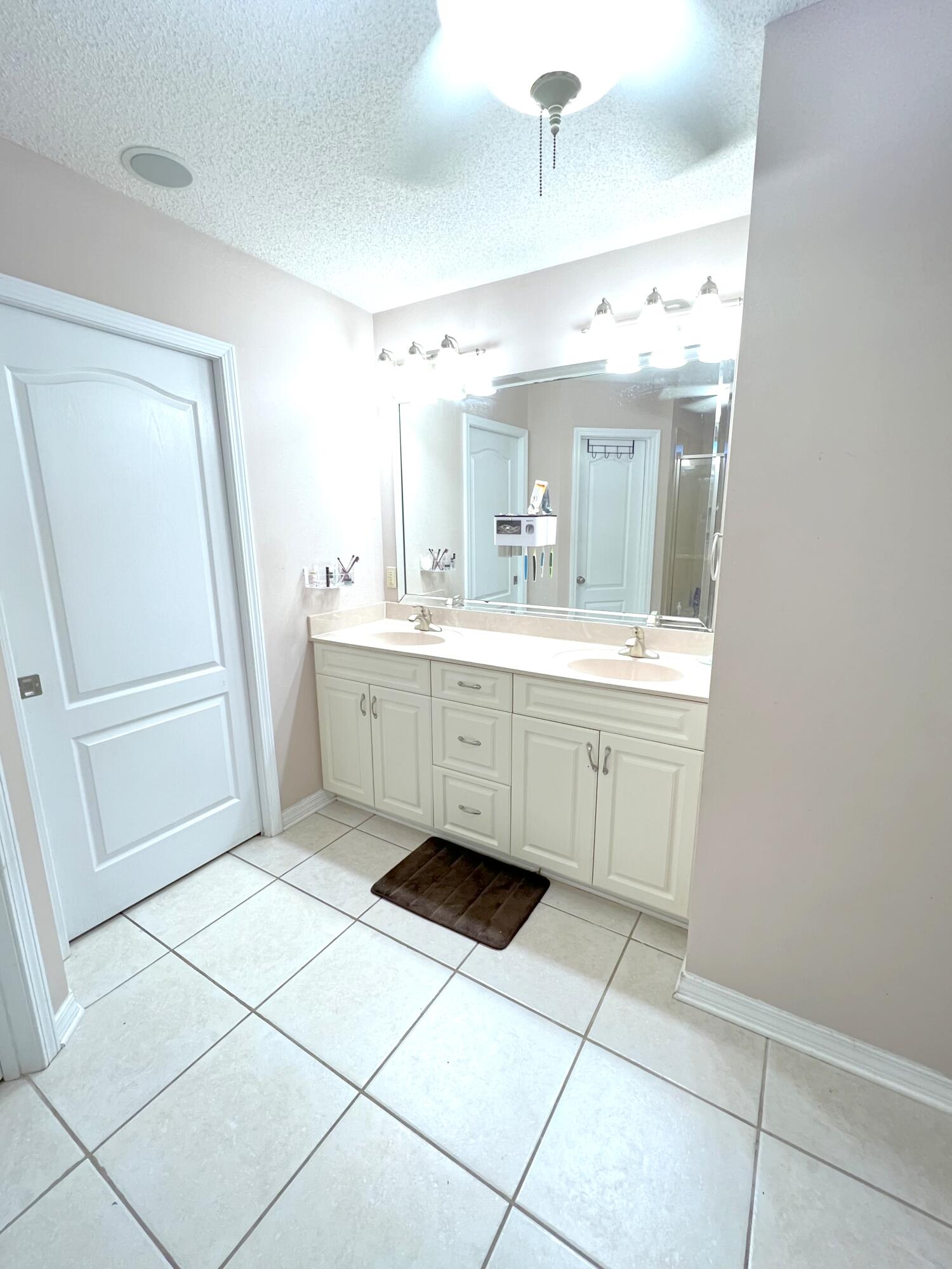 5633 North Brook Drive Crestview, FL 32539 - Photo 9 of 28 a bathroom with a sink a mirror and a shower