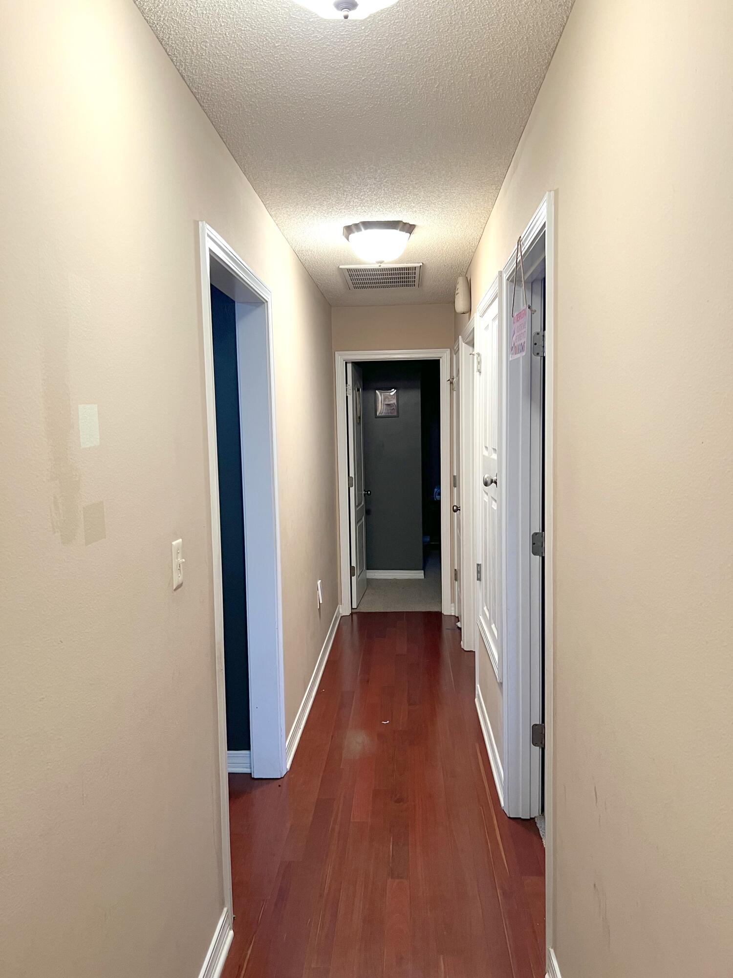5633 North Brook Drive Crestview, FL 32539 - Photo 10 of 28 a view of a hallway with wooden floor