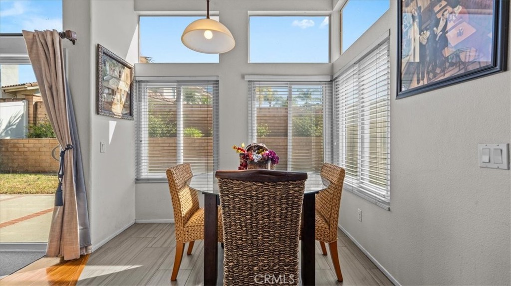 1671 Dominguez Ranch Road Corona, CA 92878 - Photo 11 of 42 A charming breakfast area surrounded by windows, offering plenty of natural light and a cozy spot for casual dining with views of the outdoor space.