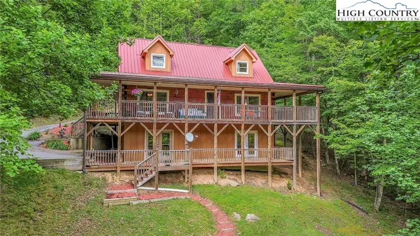 a view of a house with a yard and sitting area
