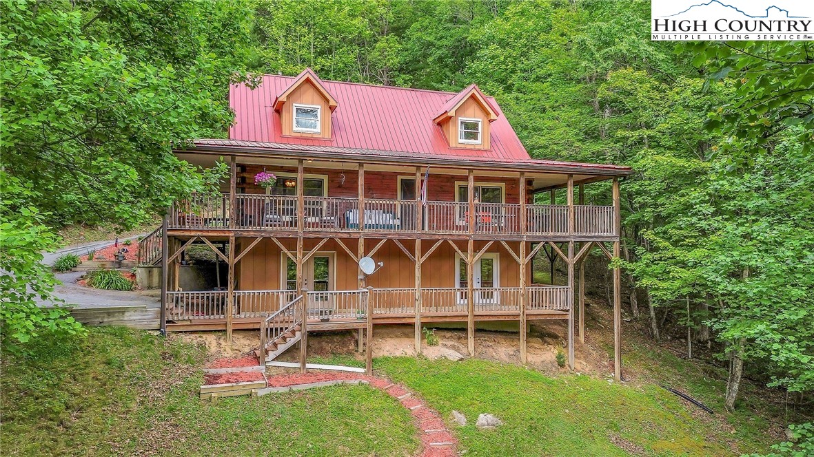 a view of a house with a yard and sitting area