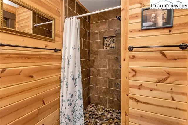 a view of a balcony with wooden floor and bench
