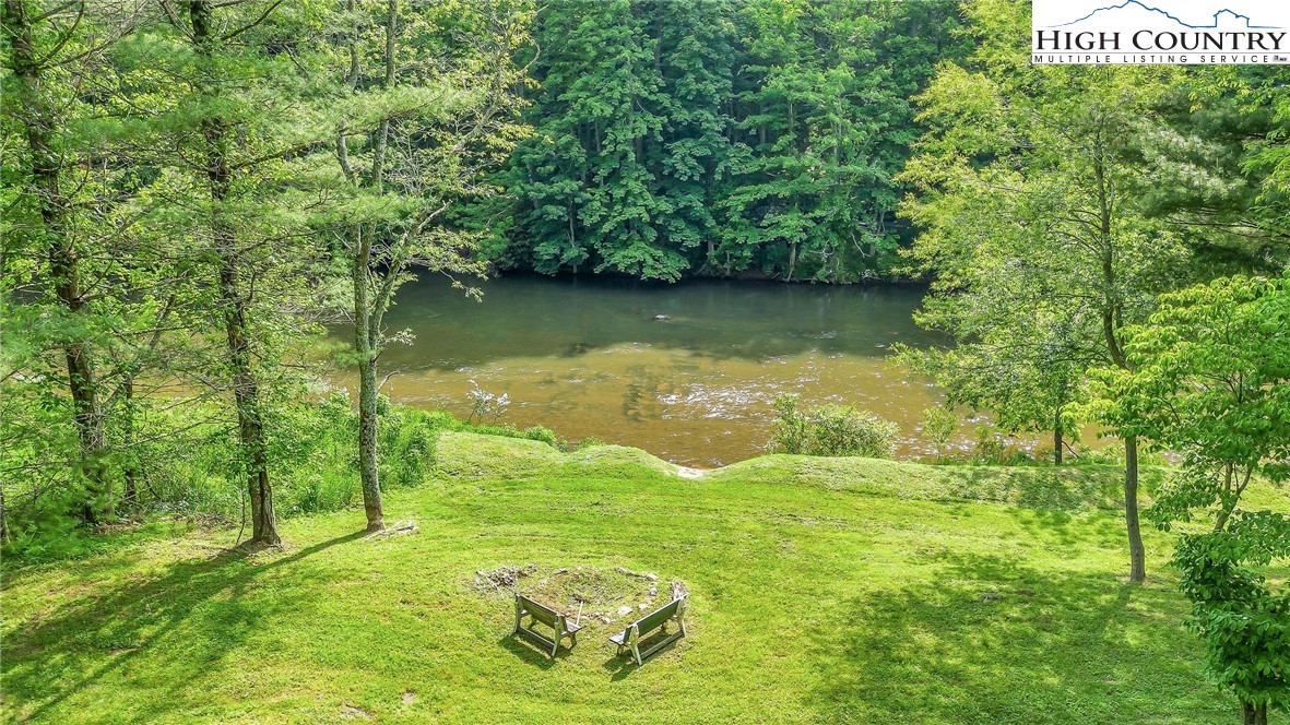1459 River Front Ridge Drive Jefferson, NC 28640 - Photo 19 of 33 a backyard of a house with lots of green space and fountain