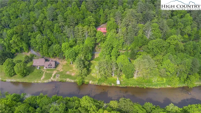 a view of a hallway with furniture and a shower