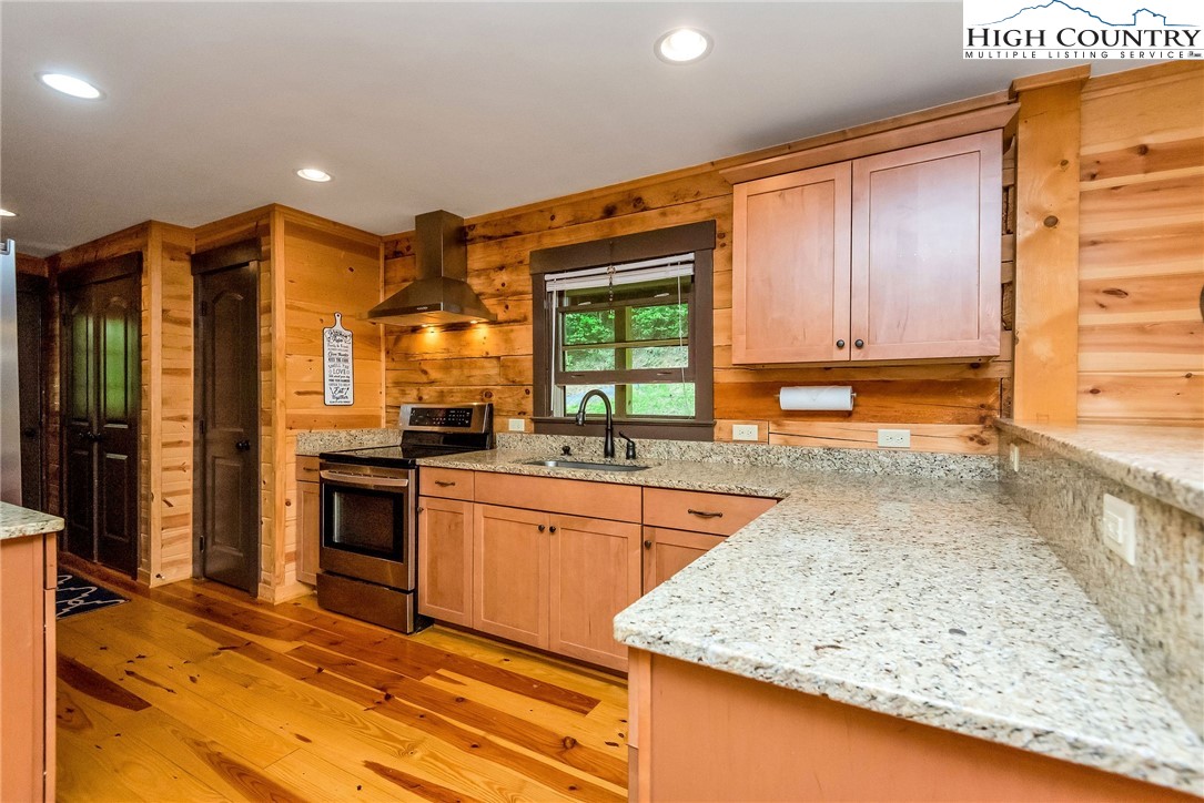 1459 River Front Ridge Drive Jefferson, NC 28640 - Photo 7 of 33 a kitchen with stainless steel appliances granite countertop wooden cabinets a oven and granite counter tops with a large window