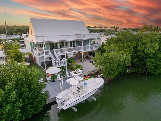 a view of a patio with couches table and chairs and potted plants
