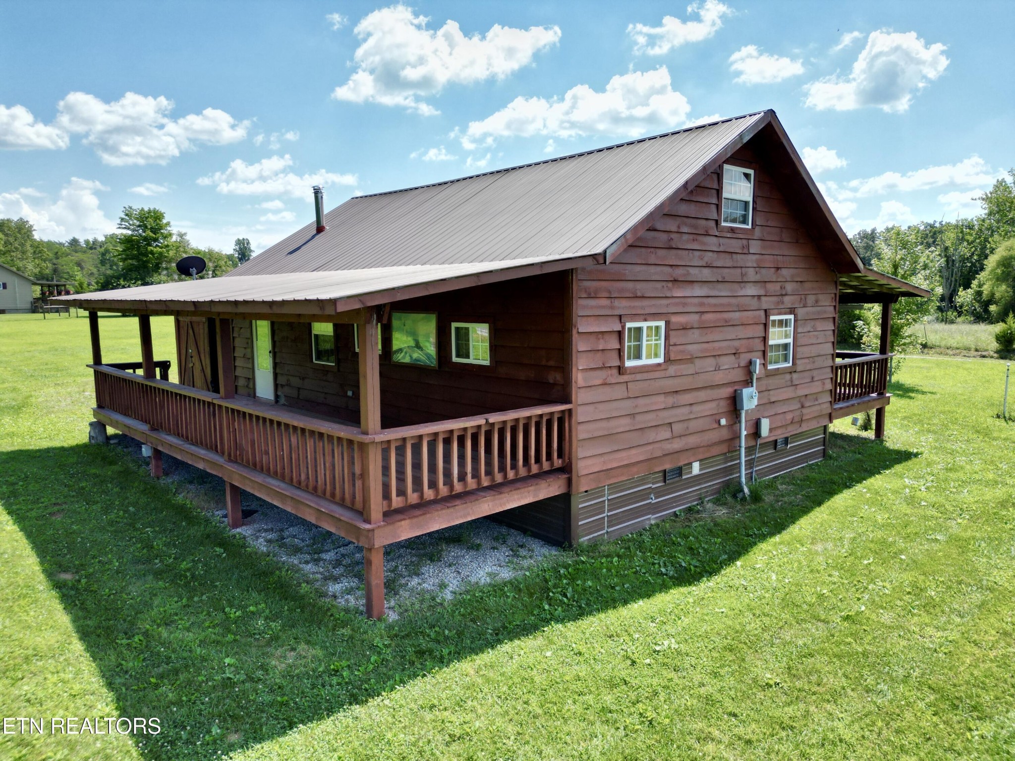 a view of a backyard with wooden fence
