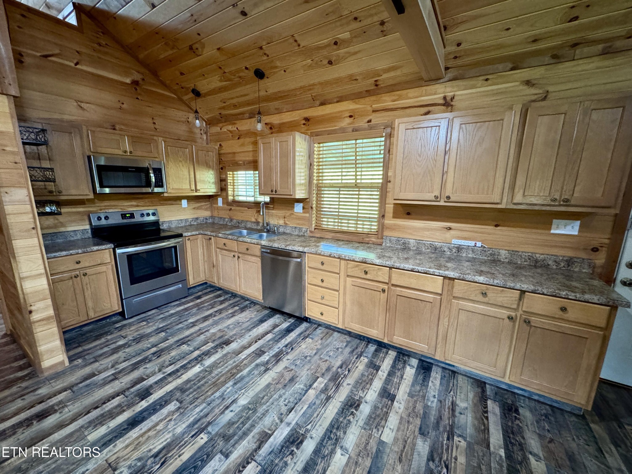 1336 Baldwin Gulf Road Clarkrange, TN 38553 - Photo 13 of 47 a kitchen with stainless steel appliances granite countertop wooden cabinets a sink and dishwasher a stove with wooden floor