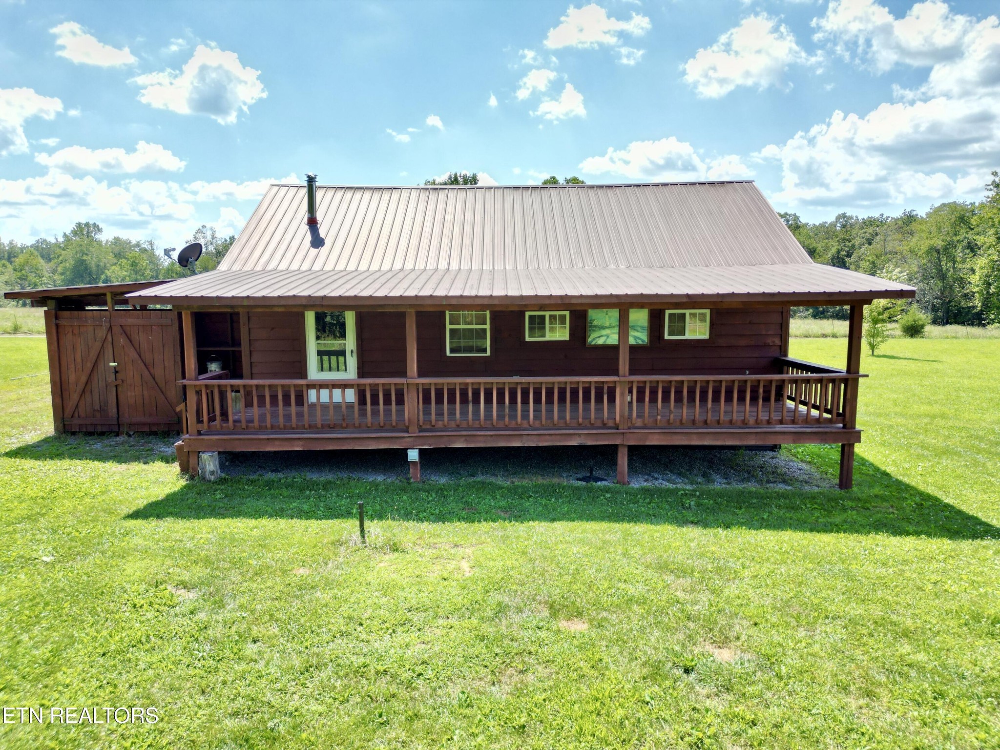 1336 Baldwin Gulf Road Clarkrange, TN 38553 - Photo 10 of 47 a view of a house with wooden deck and a yard