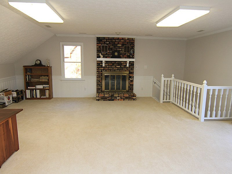 5016 Trail Ridge Drive Raleigh, NC 27613 - Photo 21 of 25 Huge Bonus Room with hall access and back stair access. Great party room with wet bar, fireplace, and sliding glass door to balcony overlooking wooded backyard. Bonus Room