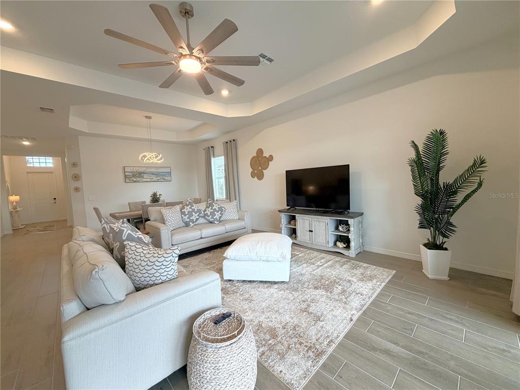 13081 Tulum Loop Venice, FL 34293 - Photo 12 of 48 a living room with furniture and a flat screen tv