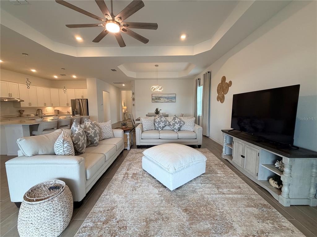 13081 Tulum Loop Venice, FL 34293 - Photo 14 of 48 a living room with furniture and a flat screen tv