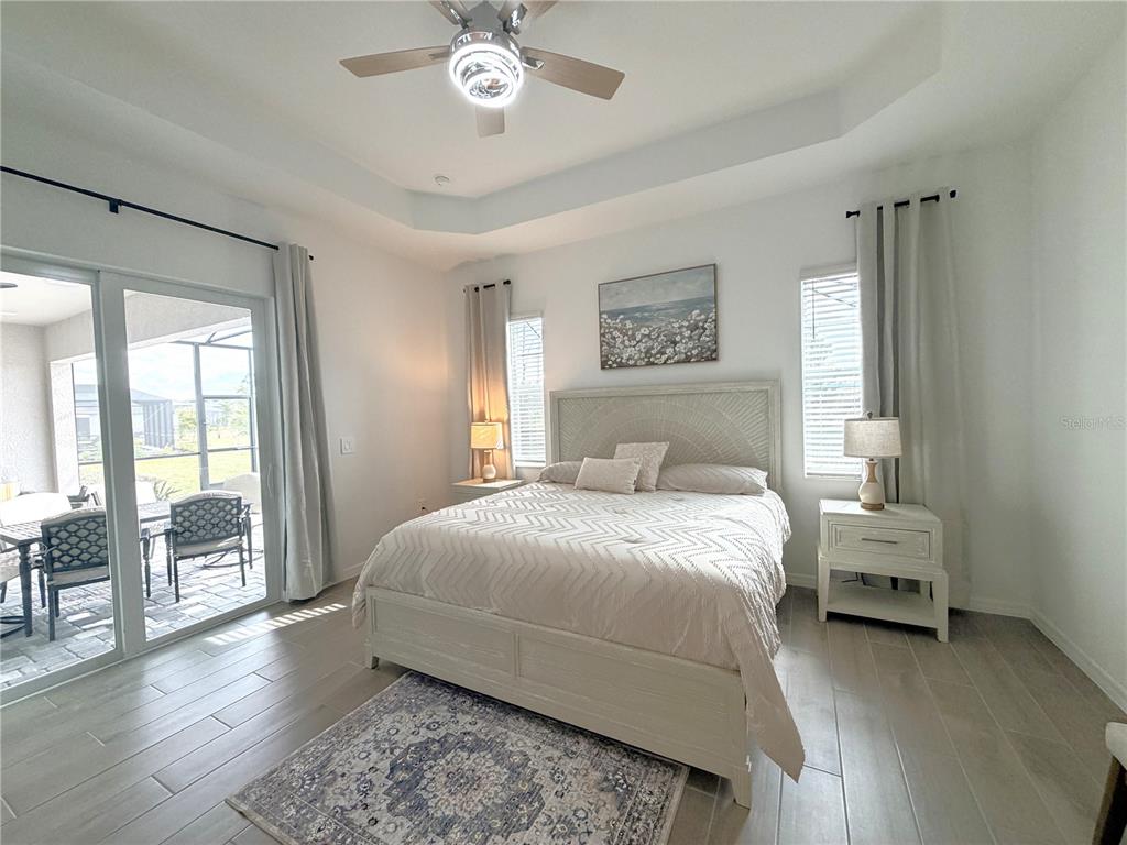 13081 Tulum Loop Venice, FL 34293 - Photo 17 of 48 a bedroom with a bed and a chandelier