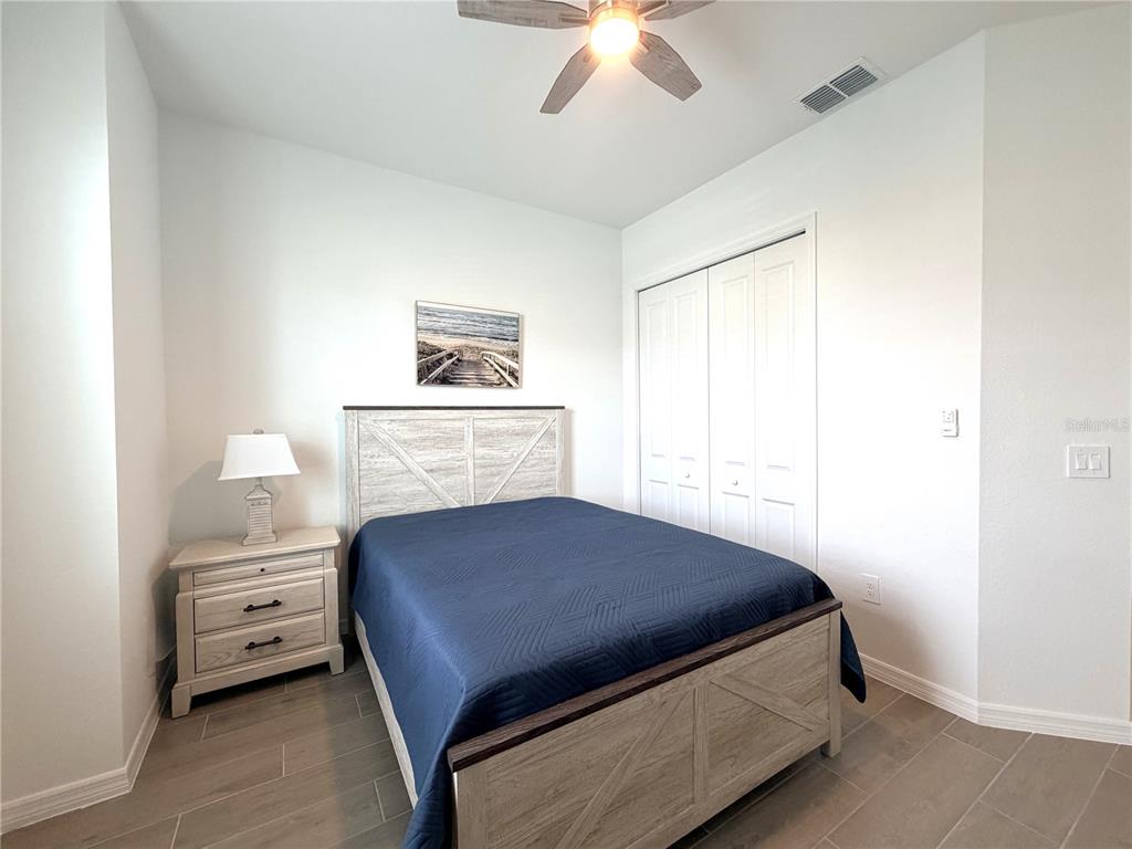 13081 Tulum Loop Venice, FL 34293 - Photo 19 of 48 a bedroom with a bed and a dresser