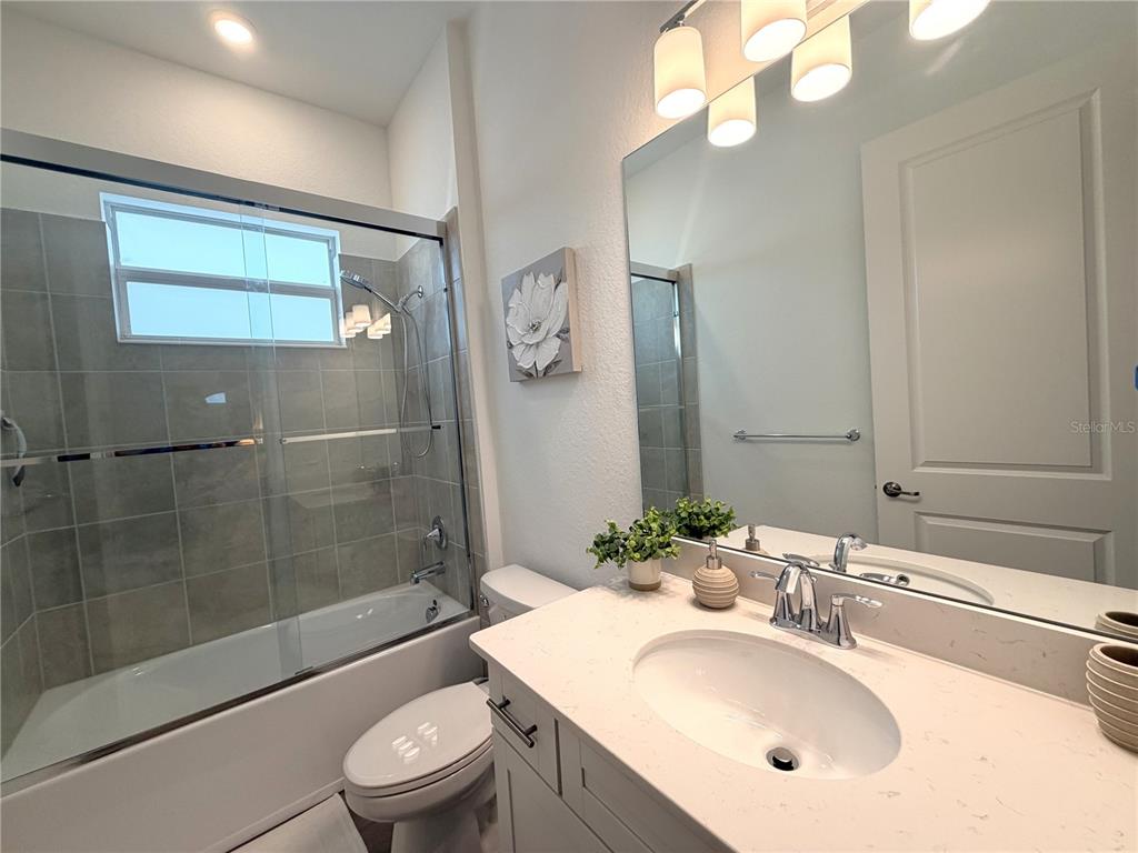 13081 Tulum Loop Venice, FL 34293 - Photo 21 of 48 a bathroom with a sink a toilet and shower