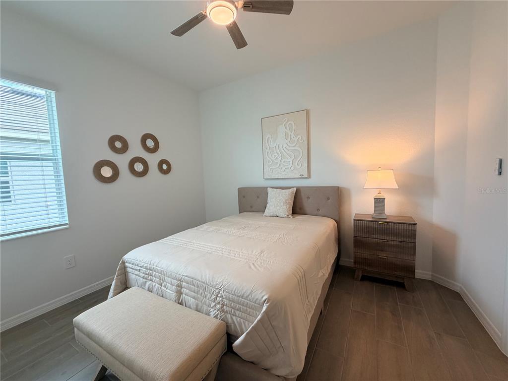 13081 Tulum Loop Venice, FL 34293 - Photo 22 of 48 a bedroom with a bed and a chandelier