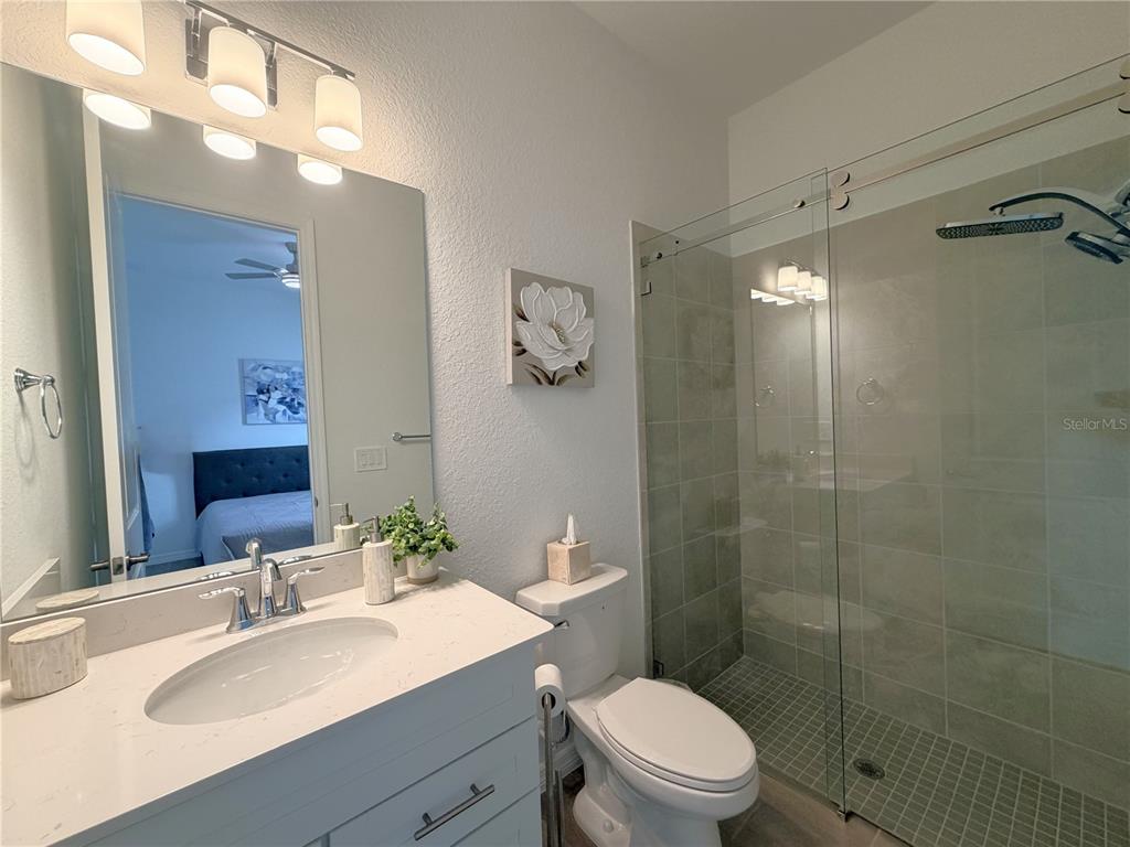 13081 Tulum Loop Venice, FL 34293 - Photo 24 of 48 a bathroom with a sink toilet and shower