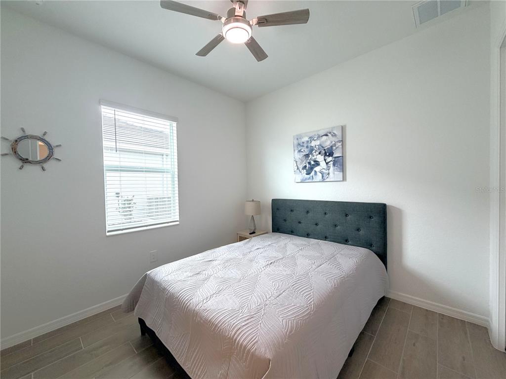 13081 Tulum Loop Venice, FL 34293 - Photo 26 of 48 a bedroom with a large bed and a window