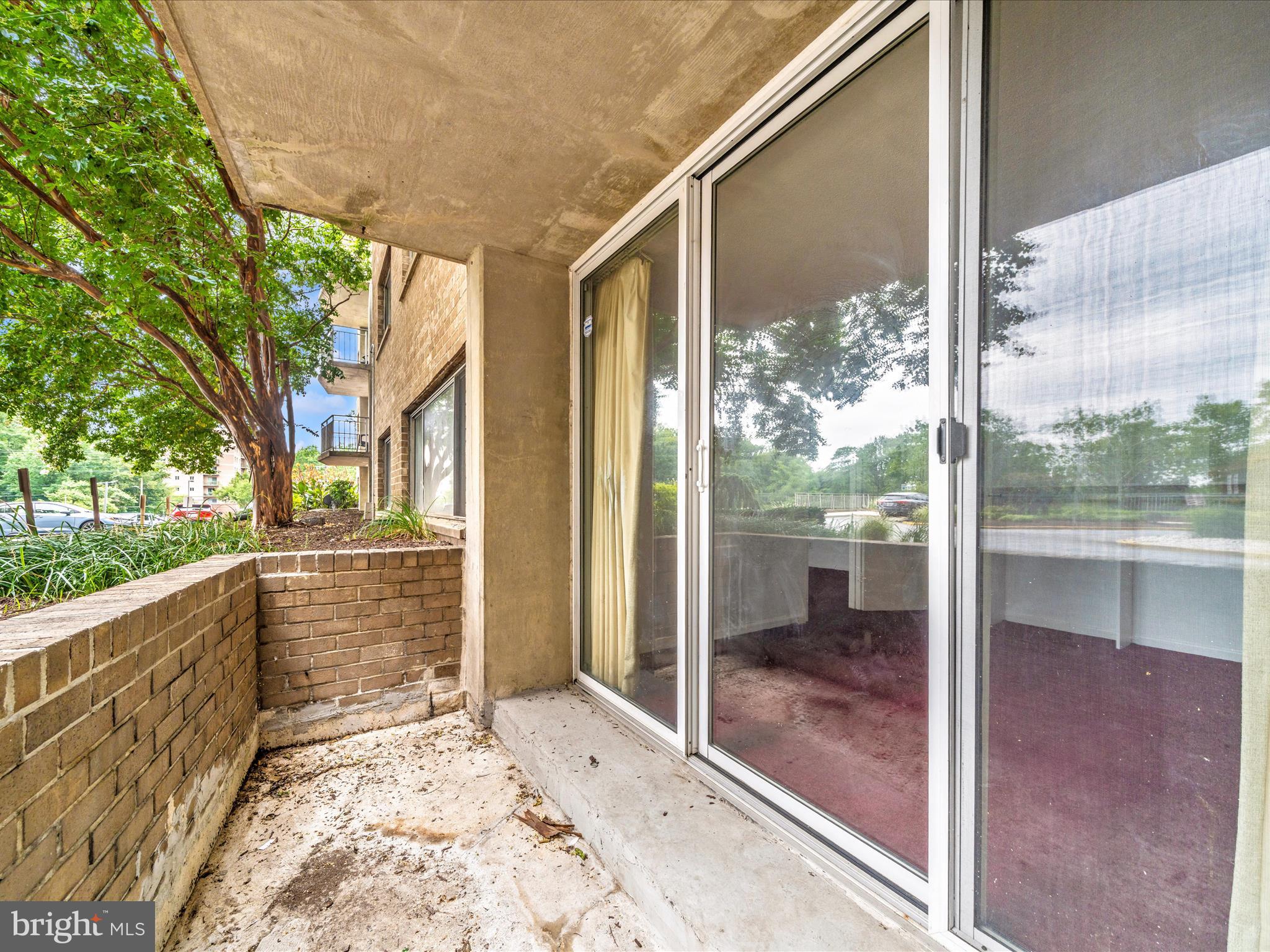 1836 Metzerott Road, Unit 106 Hyattsville, MD 20783 - Photo 41 of 54 a view of a glass door and porch next to a yard