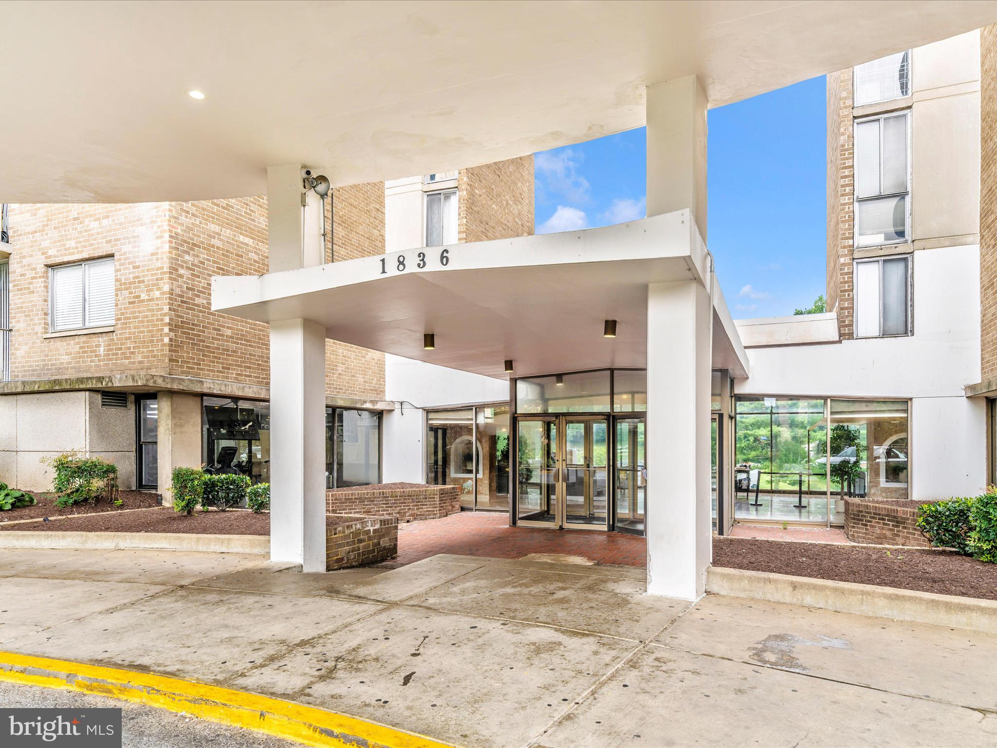 1836 Metzerott Road, Unit 106 Hyattsville, MD 20783 - Photo 53 of 54 a view of a building with a swimming pool and outdoor seating