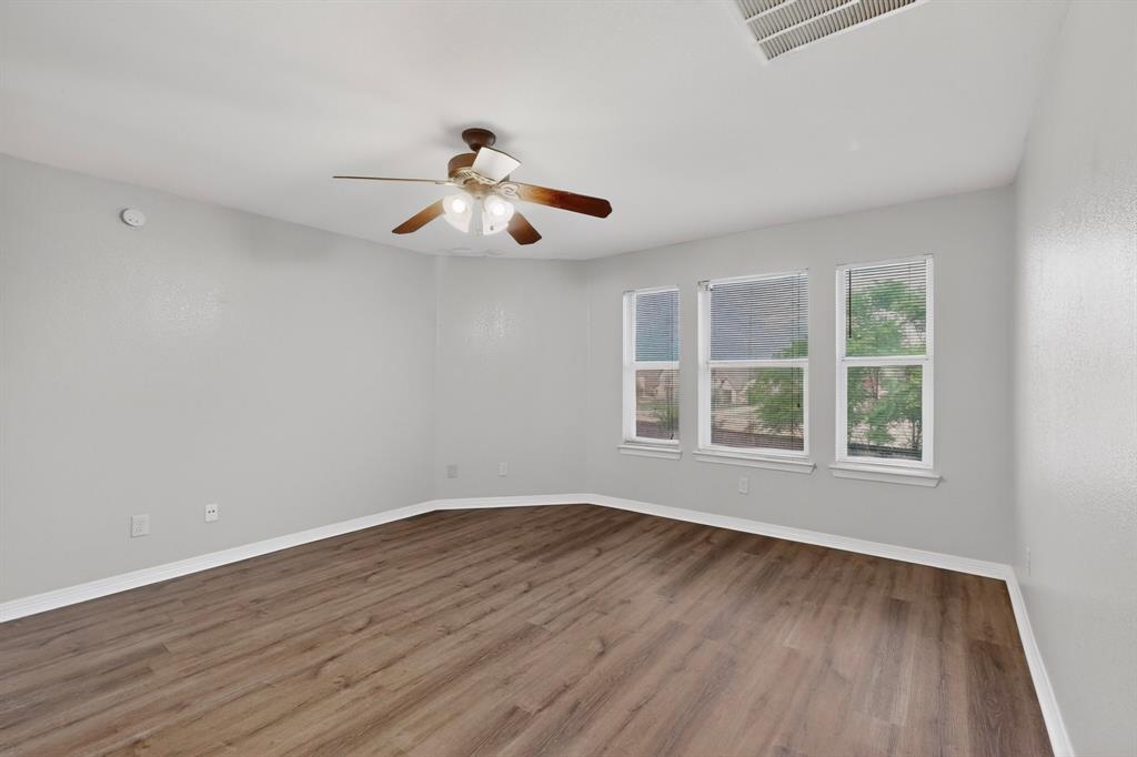 3401 Newgate Street Midlothian, TX 76065 - Photo 32 of 34 Spacious room featuring wood-finish flooring, light gray walls, white baseboards, and a ceiling fan with integrated lighting
