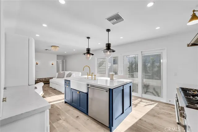 a large white kitchen with a large window