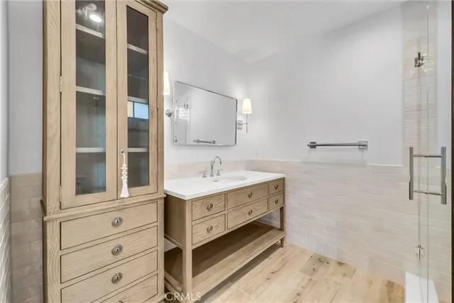 a bathroom with a sink double vanity and a shower