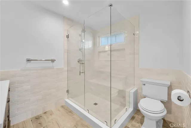 a bathroom with a shower and a toilet