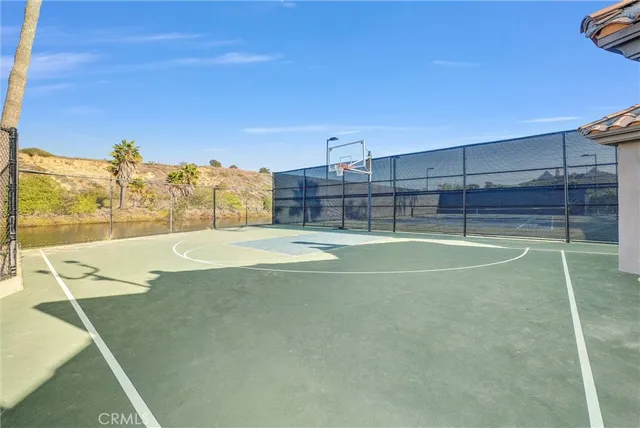a view of a swimming pool with a fountain and a bench