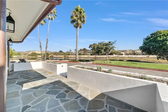 a view of a swimming pool with a lawn chairs under an umbrella