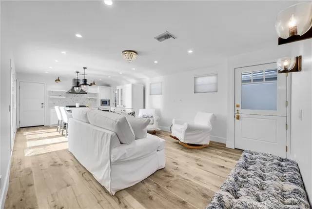 a living room with furniture and kitchen view