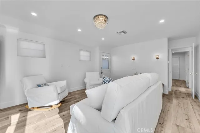 a spacious bedroom with a bed and a lamp