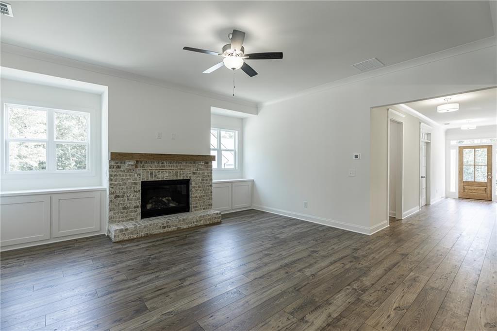 1210 Austin Road Winder, GA 30680 - Photo 21 of 56 a view of a livingroom with a fireplace wooden floor and windows