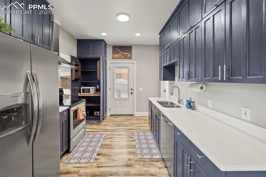 1904 Sheldon Avenue Colorado Springs, CO 80904 - Photo 11 of 40 a kitchen with stainless steel appliances granite countertop a refrigerator stove and oven